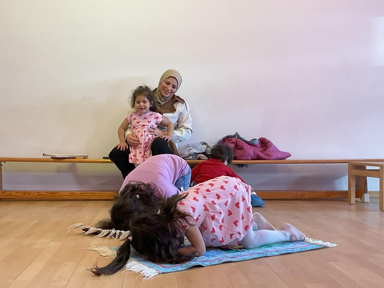 Die Kinder zeigen, wie ihre Eltern beten